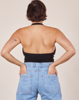 Back view of Halter Top in Basic Black and light wash Frontier Jeans worn by Tiara