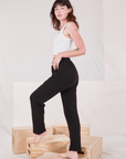 Side view of Rolled Cuff Sweat Pants in Basic Black and Cropped Tank in vintage tee off-white on Alex