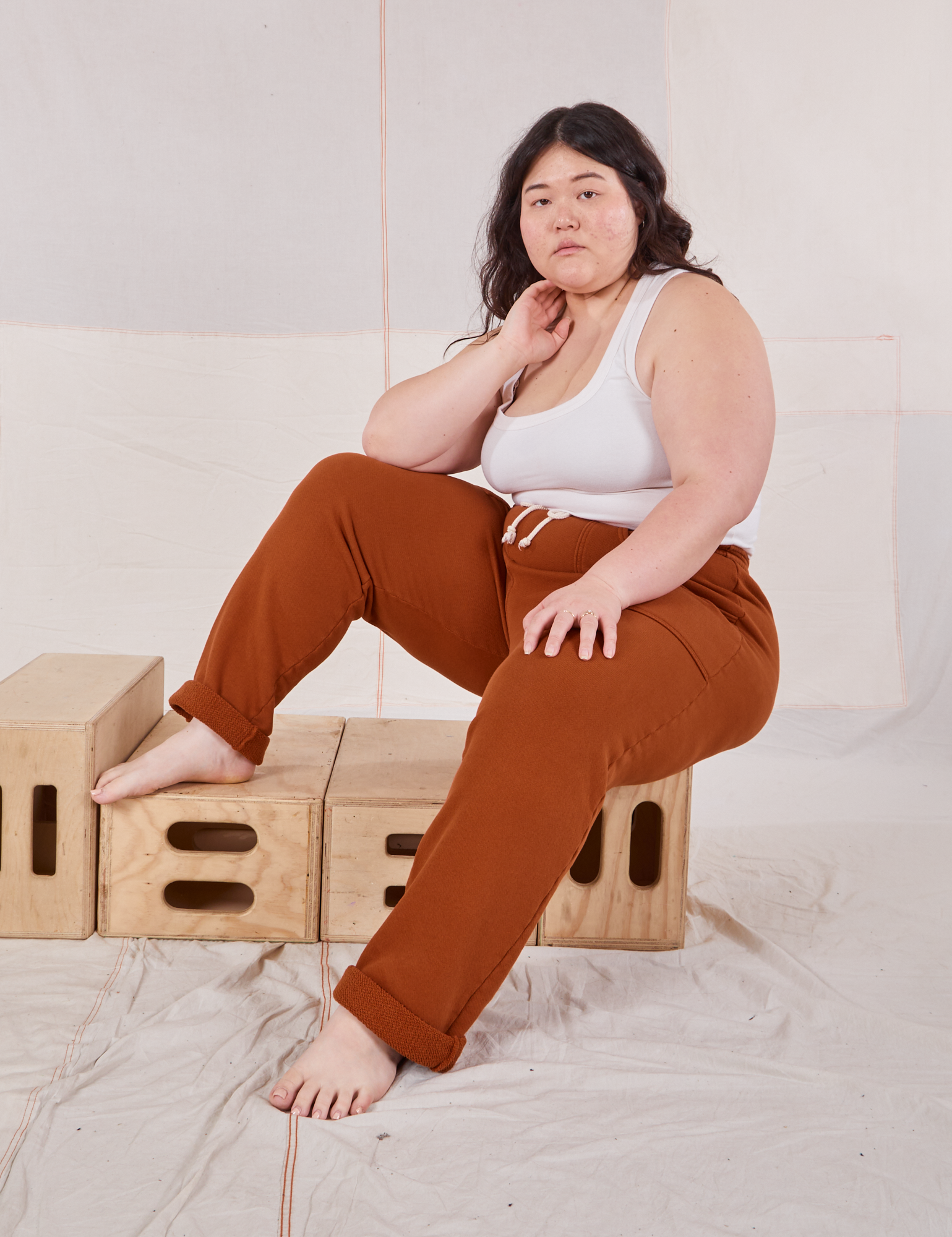 Ashley is wearing Rolled Cuff Sweat Pants in Burnt Terracotta and Cropped Tank in vintage tee off-white