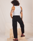 Back view of Heavyweight Trousers in Basic Black and Cropped Tank Top in vintage tee off-white worn by Jesse