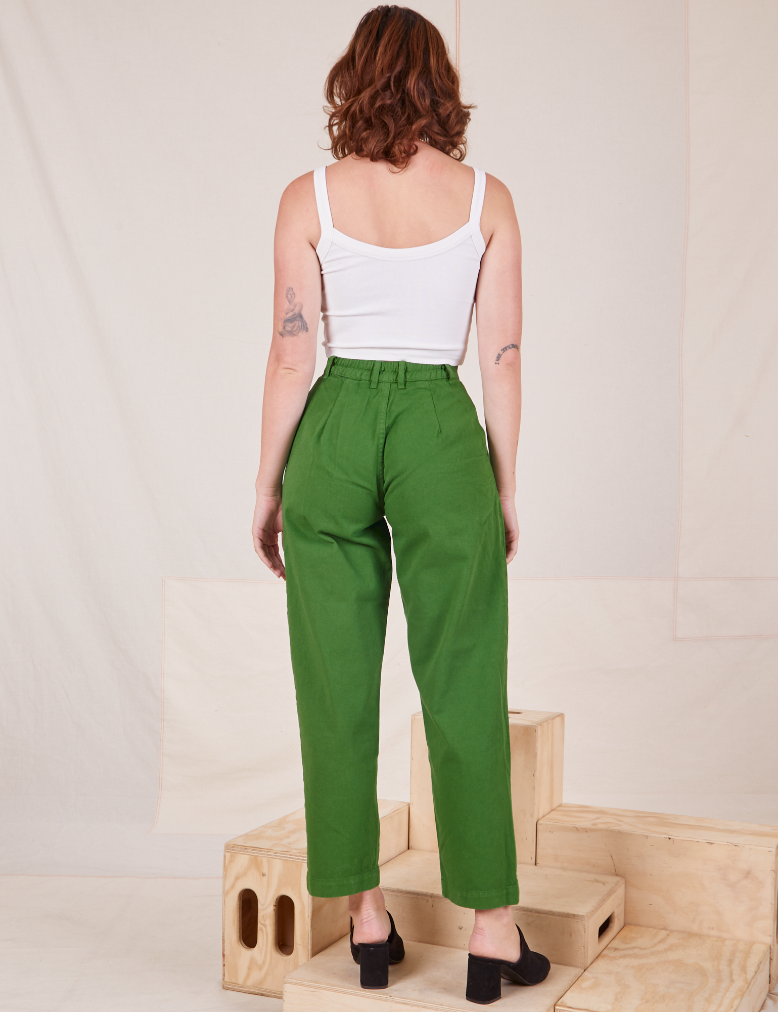 Back view of Heavyweight Trousers in Lawn Green and Cropped Cami in vintage tee off-white worn by Alex