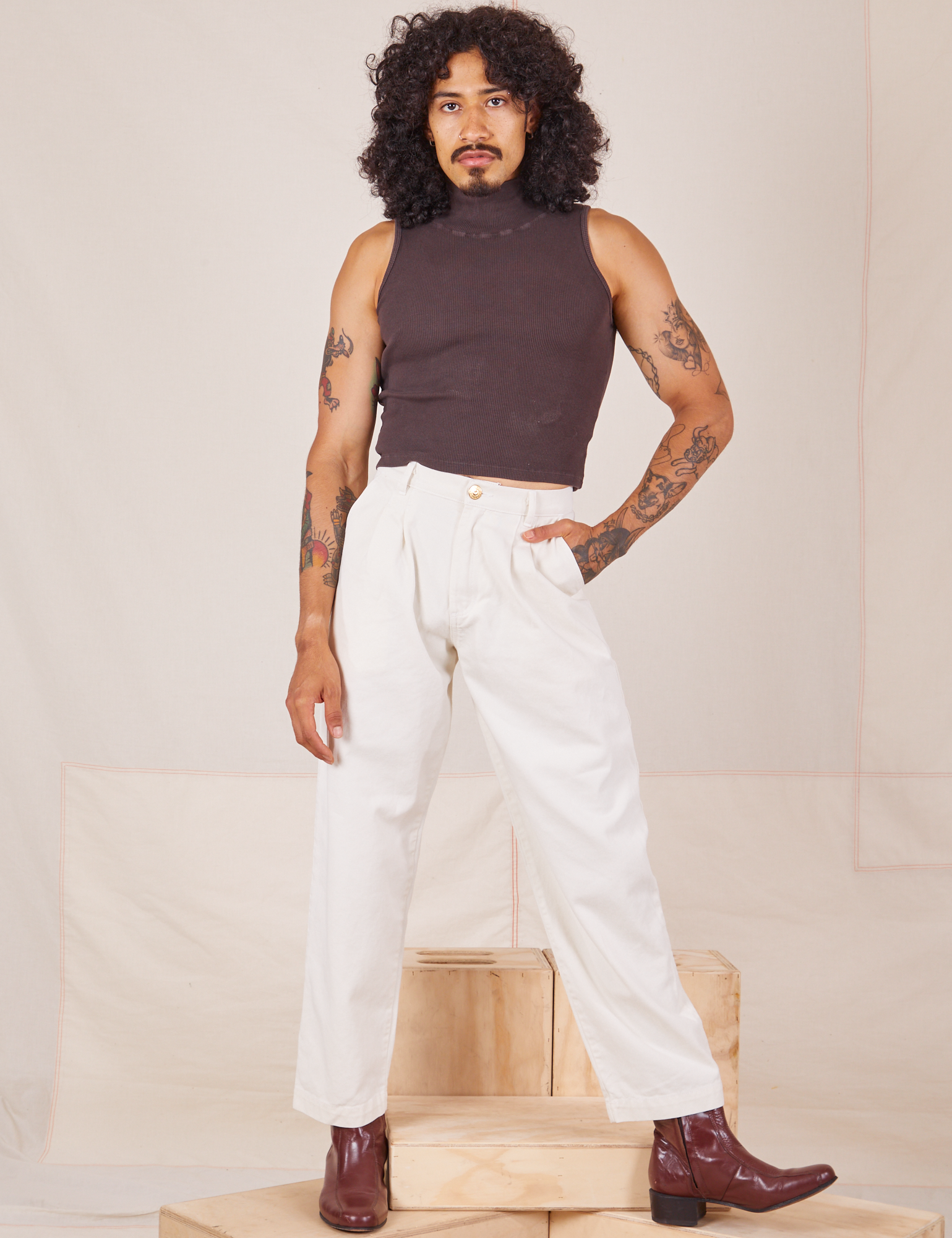 Jesse is 5&#39;8&quot; and wearing XXS Heavyweight Trousers in Vintage Tee Off-White and espresso brown Sleeveless Turtleneck.