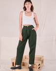 Alex is 5’8” and wearing XXS Heritage Trousers in Swamp Green paired with a Cropped Tank in vintage tee off-white