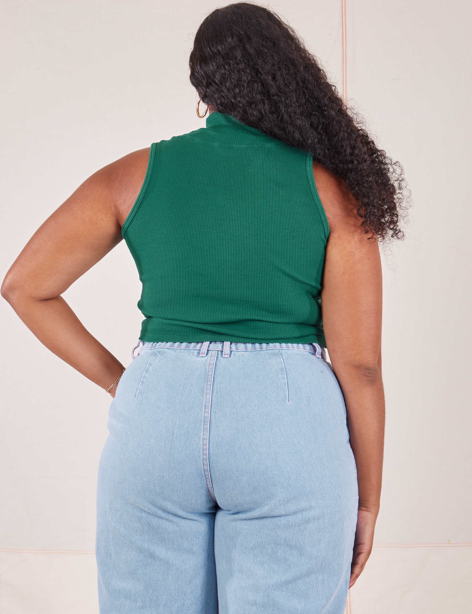 Back view of Sleeveless Essential Turtleneck in Hunter Green worn by Meghna