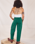 Back view of Heavyweight Trousers in Hunter Green and Halter Top in vintage tee off-white worn by Jesse