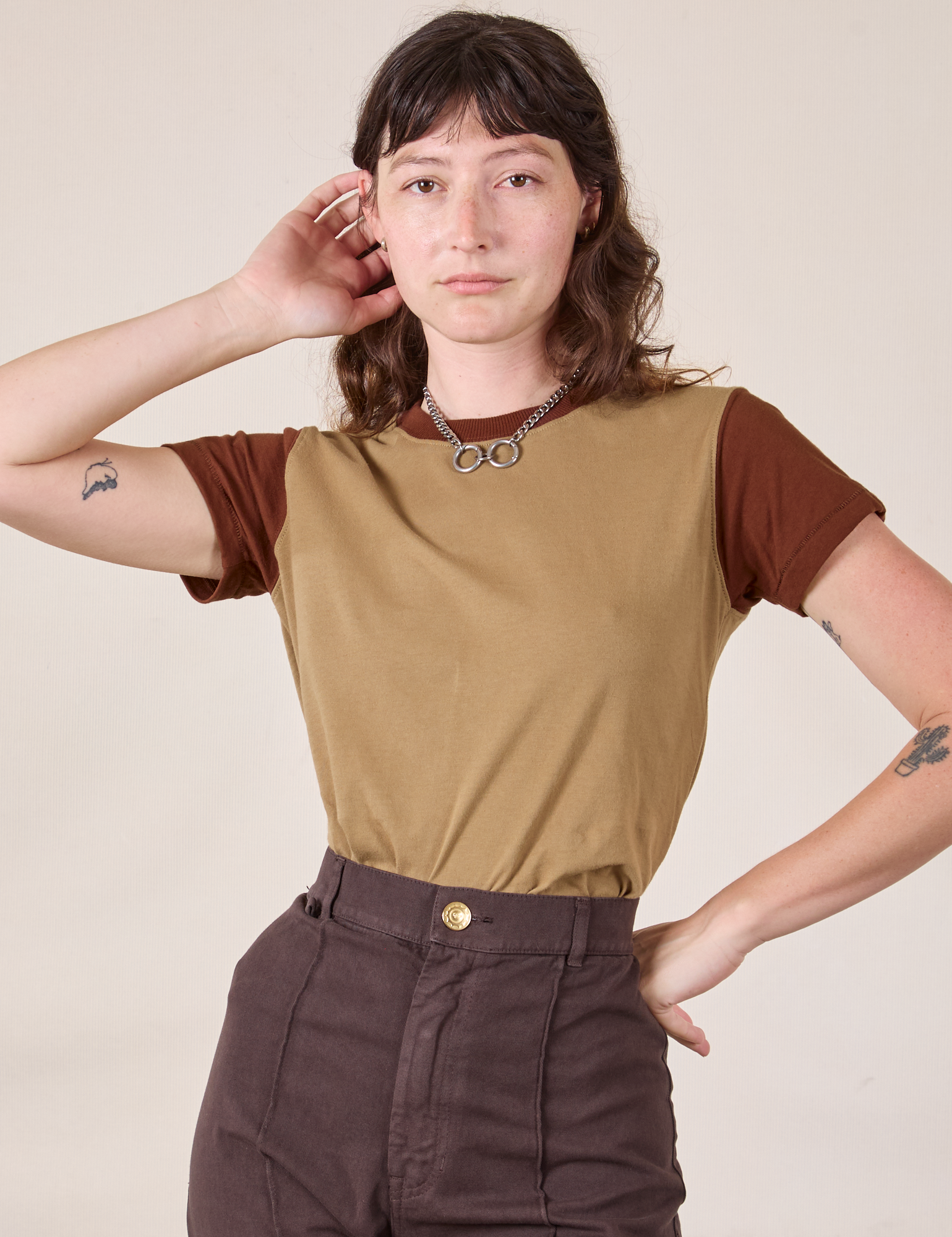 Alex is 5’8” and wearing P Mismatched Tee in Tan & Brown