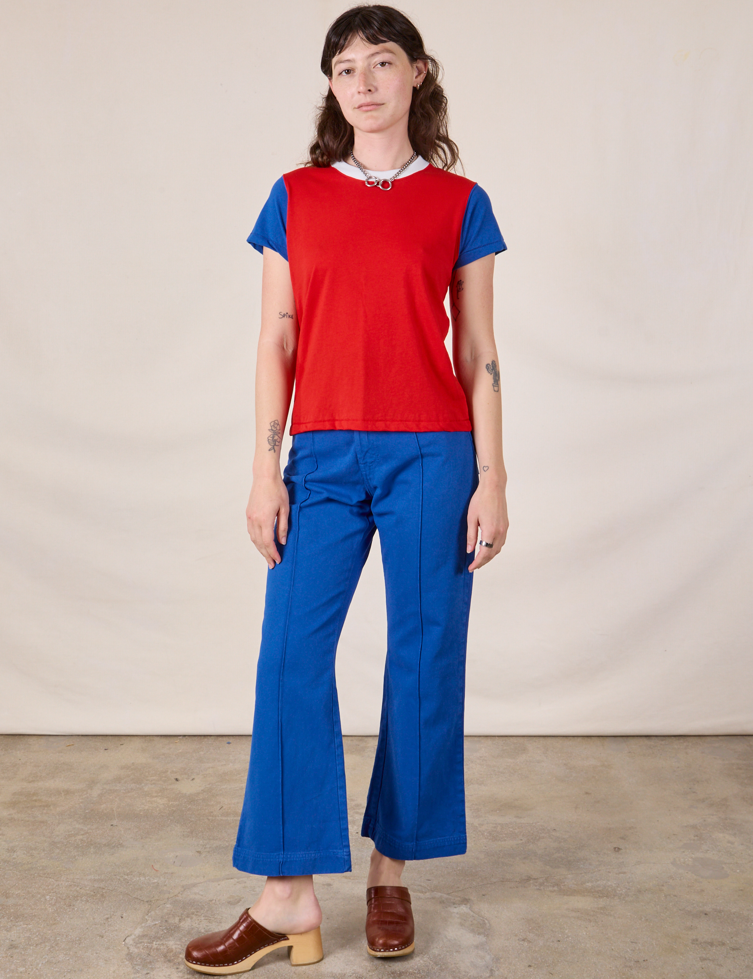 Alex is wearing Mismatched Tee in Red & Blue and royal blue Western Pants