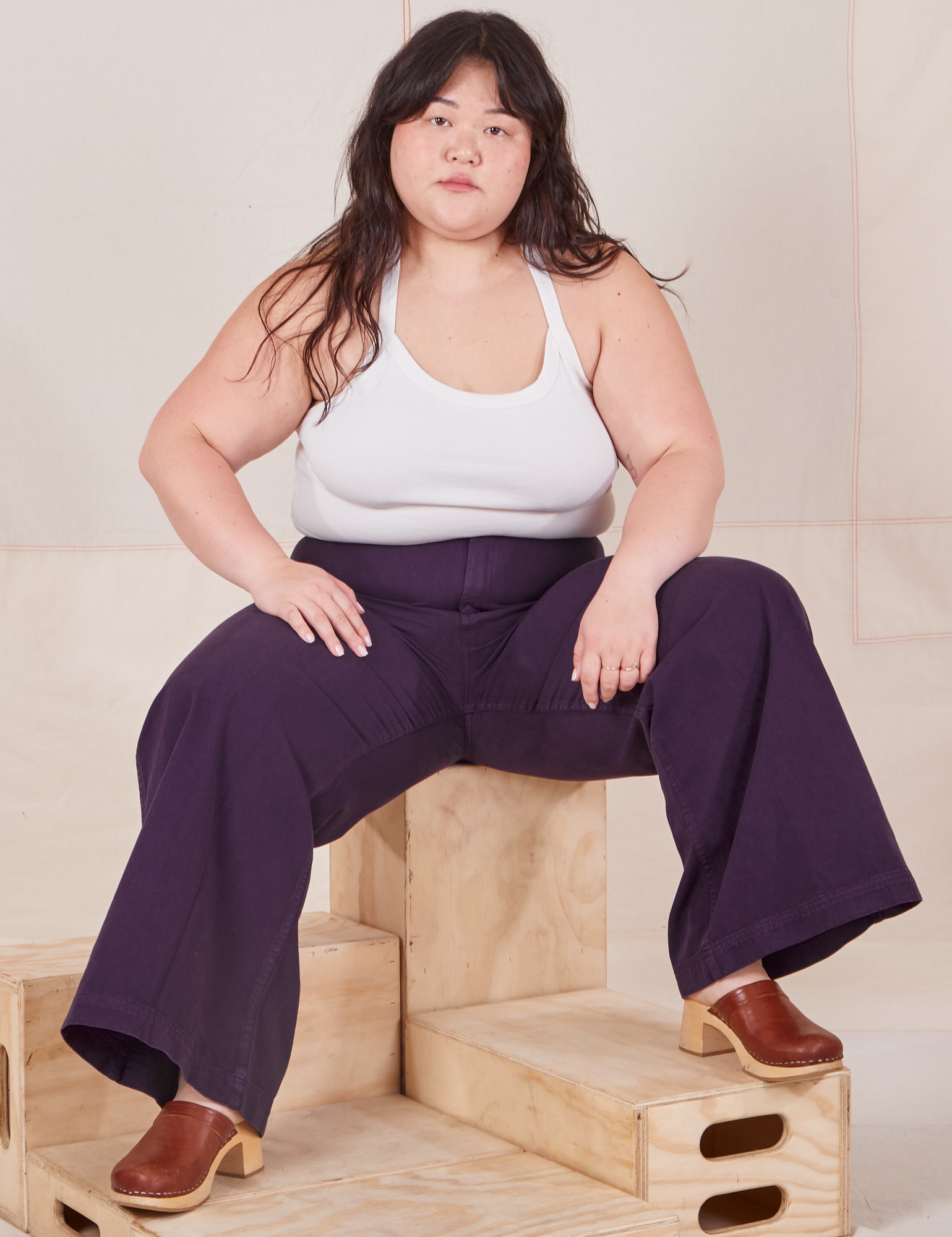 Ashley is wearing Bell Bottoms in Nebula Purple and Halter Top in vintage tee off-white