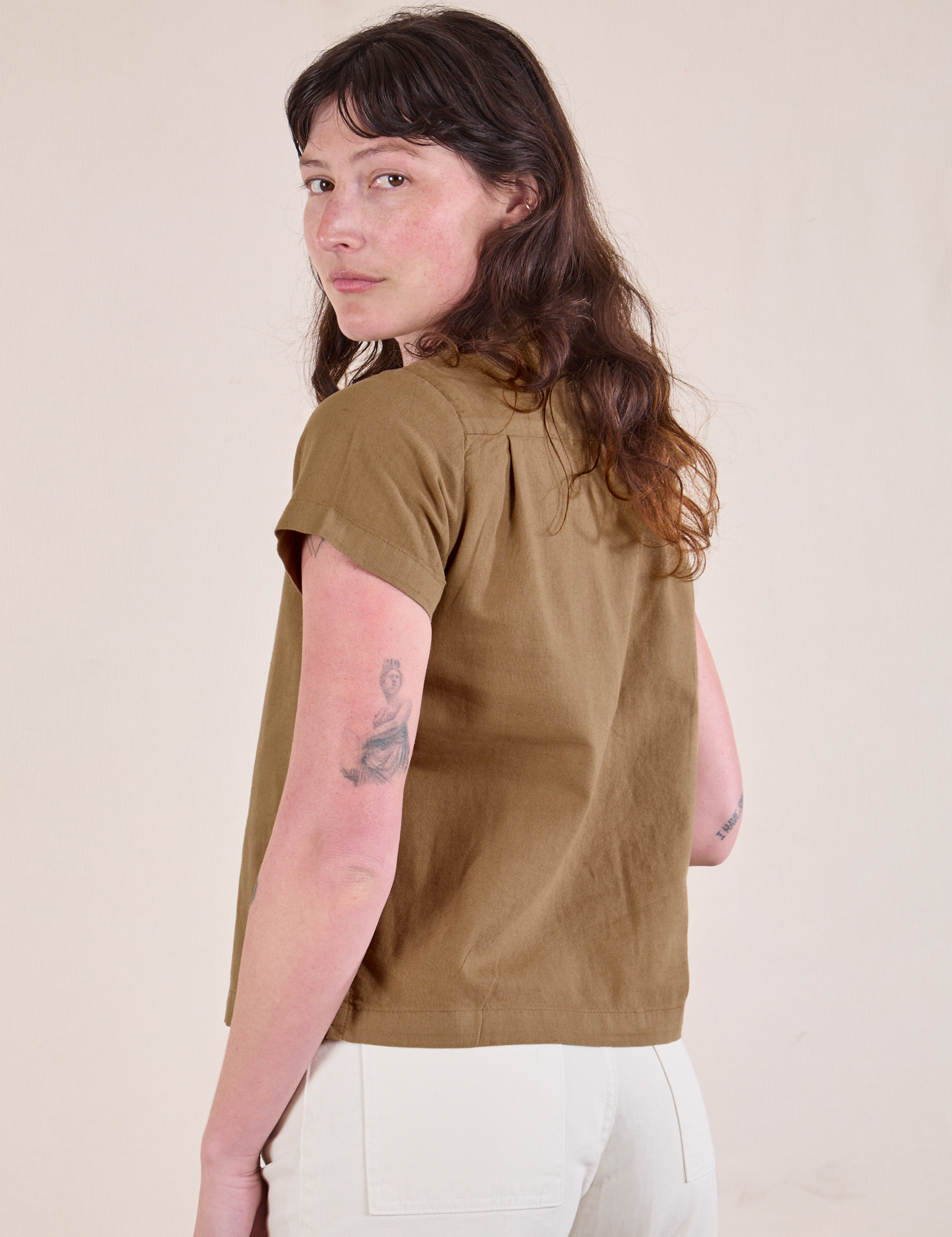 Angled back view of Pantry Button-Up in Desert Brown on Alex