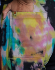 Close up of Tiara's hand in the back pocket of Work Pants in Rainbow Magic Waters