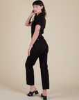 Angled back view of Short Sleeve Jumpsuit in Basic Black on Alex