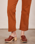 Pant leg close up of Short Sleeve Jumpsuit in Burnt Terracotta worn by Alex
