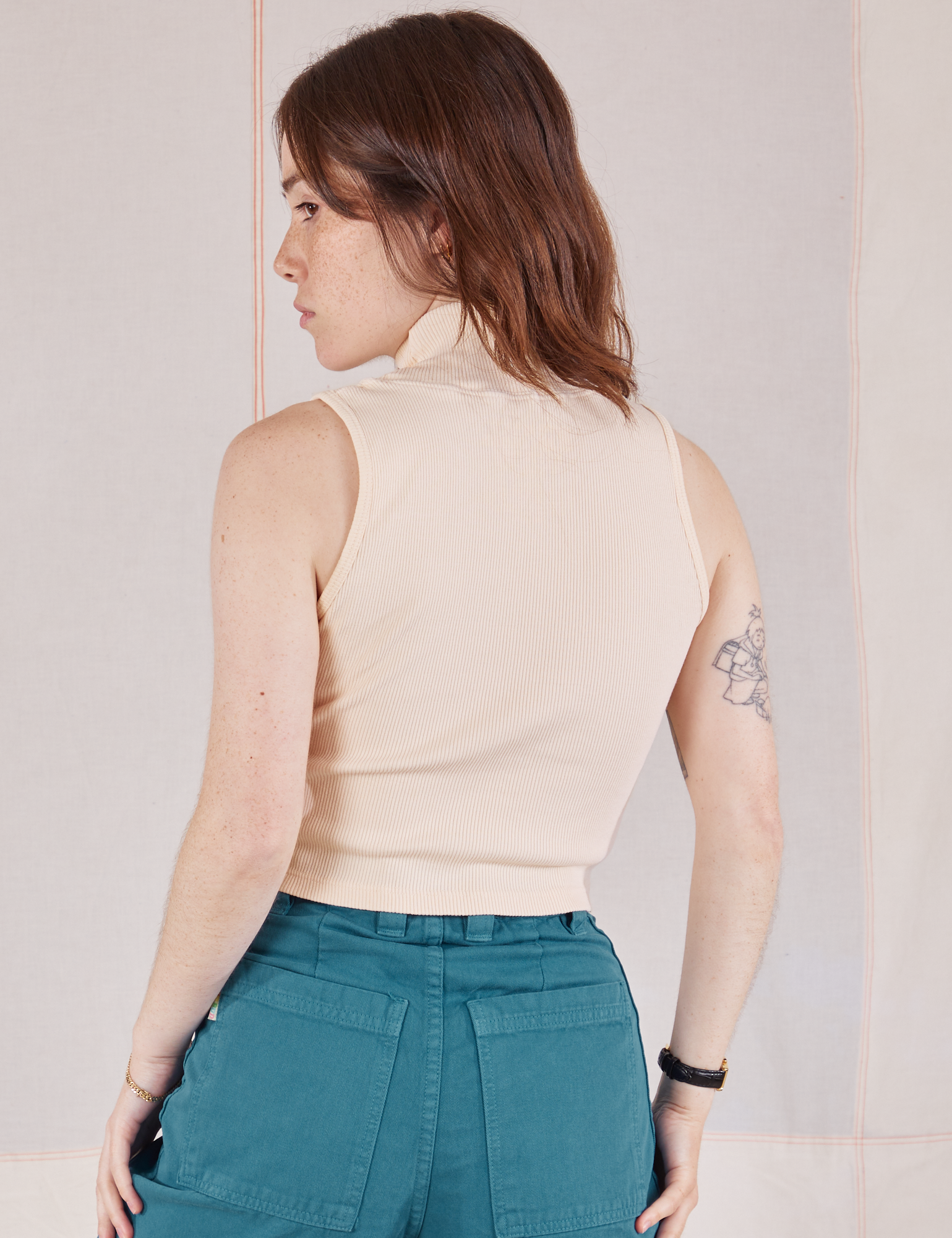 Back view of Sleeveless Essential Turtleneck in Vintage Tee Off-White on Hana