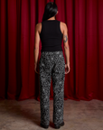 Back view of Work Pants in Spiderwebs and black Cropped Tank on Anthony