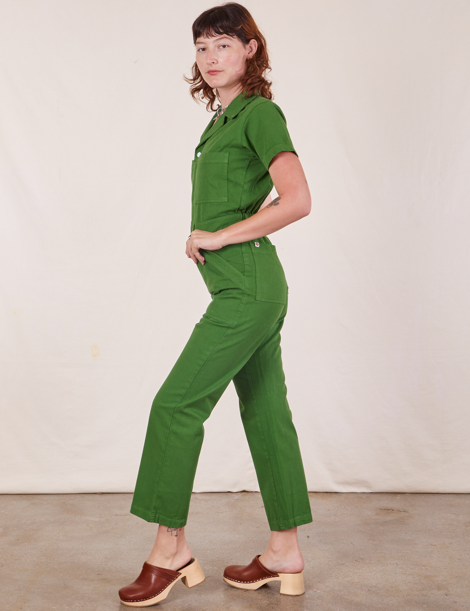Side view of Short Sleeve Jumpsuit in Lawn Green worn by Alex