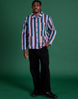 Isaac is wearing a buttoned up Stripe Work Jacket in Pacific Stripe paired with black Work Pants