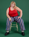 Juliet is wearing Work Pants in Pacific Stripe paired with mustang red Cropped Tank
