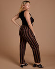 Side view of Black Stripe Work Pants in Fudgesicle Brown and black Cropped Tank on Tiara