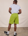 Back view of Sweat Shorts in Gross Green and Jr. Varsity Tee in Stone White on Isaac