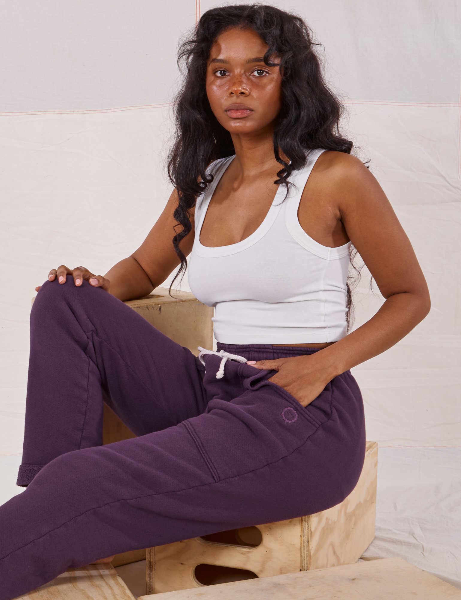 Kandia is wearing Rolled Cuff Sweat Pants in Nebula Purple and Cropped Tank in vintage tee off-white
