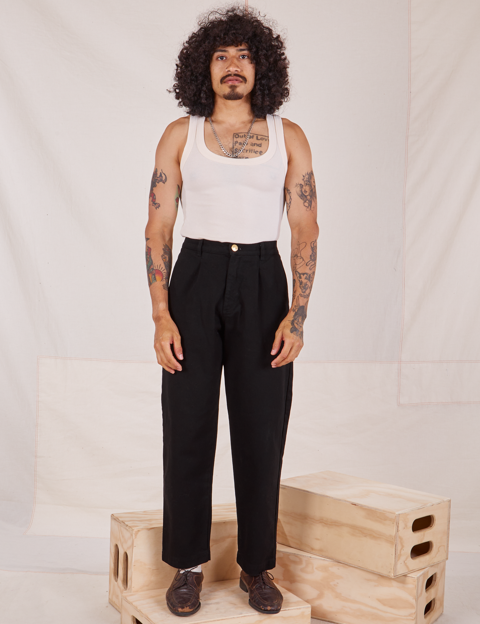 Jesse is 5&#39;8&quot; and wearing XXS Denim Trouser Jeans in Black paired with Tank Top in vintage tee off-white