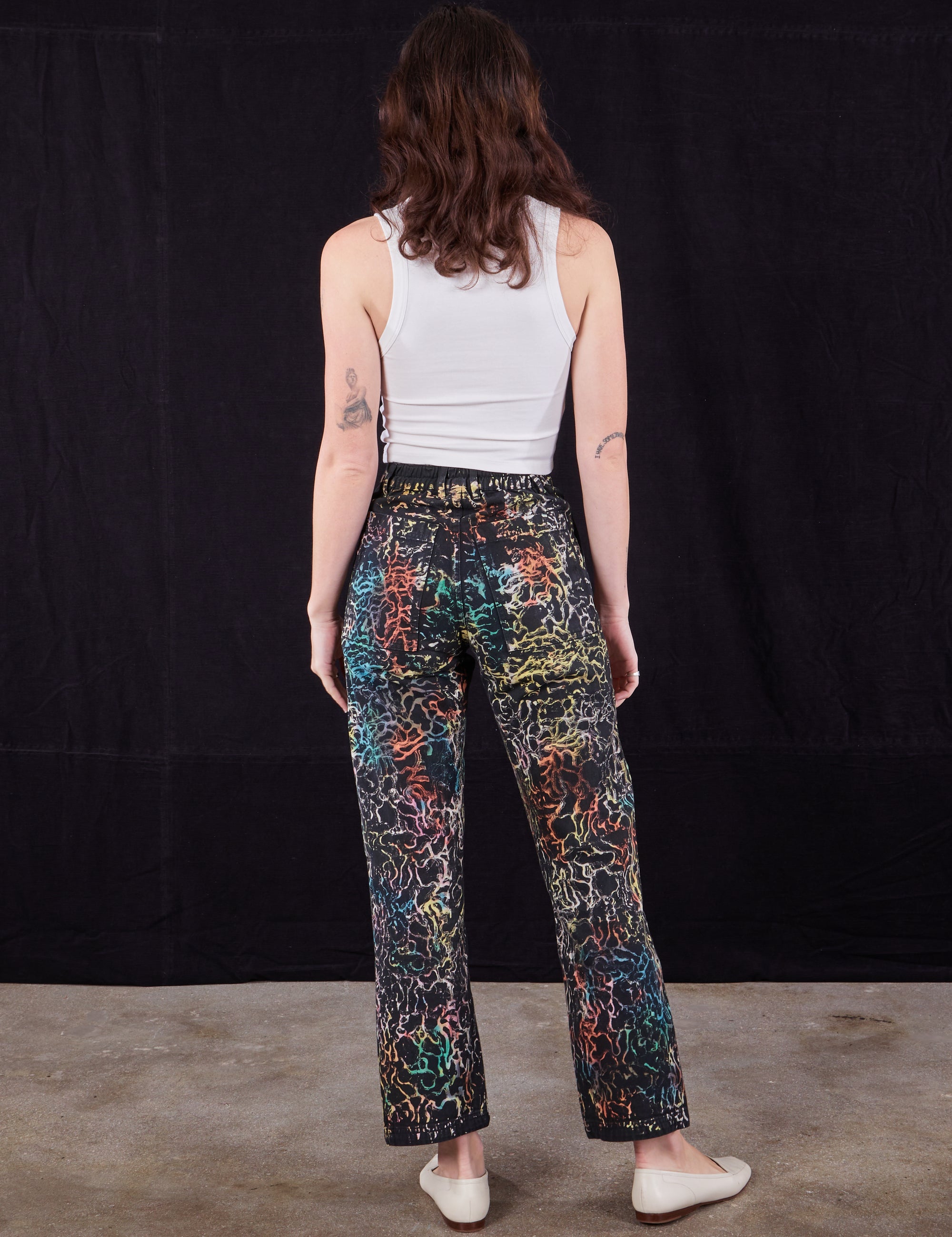 Back view of Wavy Dye Work Pants and Cropped Tank in vintage tee off-white on Alex