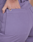 Close up of Alex's hand in the back pocket of Classic Work Shorts in Faded Grape