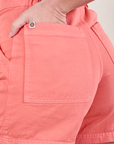 Close up of Alex's hand in the back pocket of Classic Work Shorts in Flamingo Pink