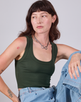 Alex is 5'8" and wearing P Cropped Tank Top in Swamp Green