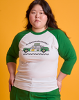 Ashley is 5'7" and wearing L Taxi Raglan Tee in Chicago