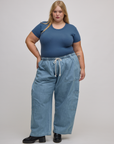 Juliet is wearing Baby Tee in French Blue tucked into light wash drop pocket cargo pants