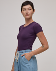 Angled front view of Baby Tee in Nebula Purple on Alex