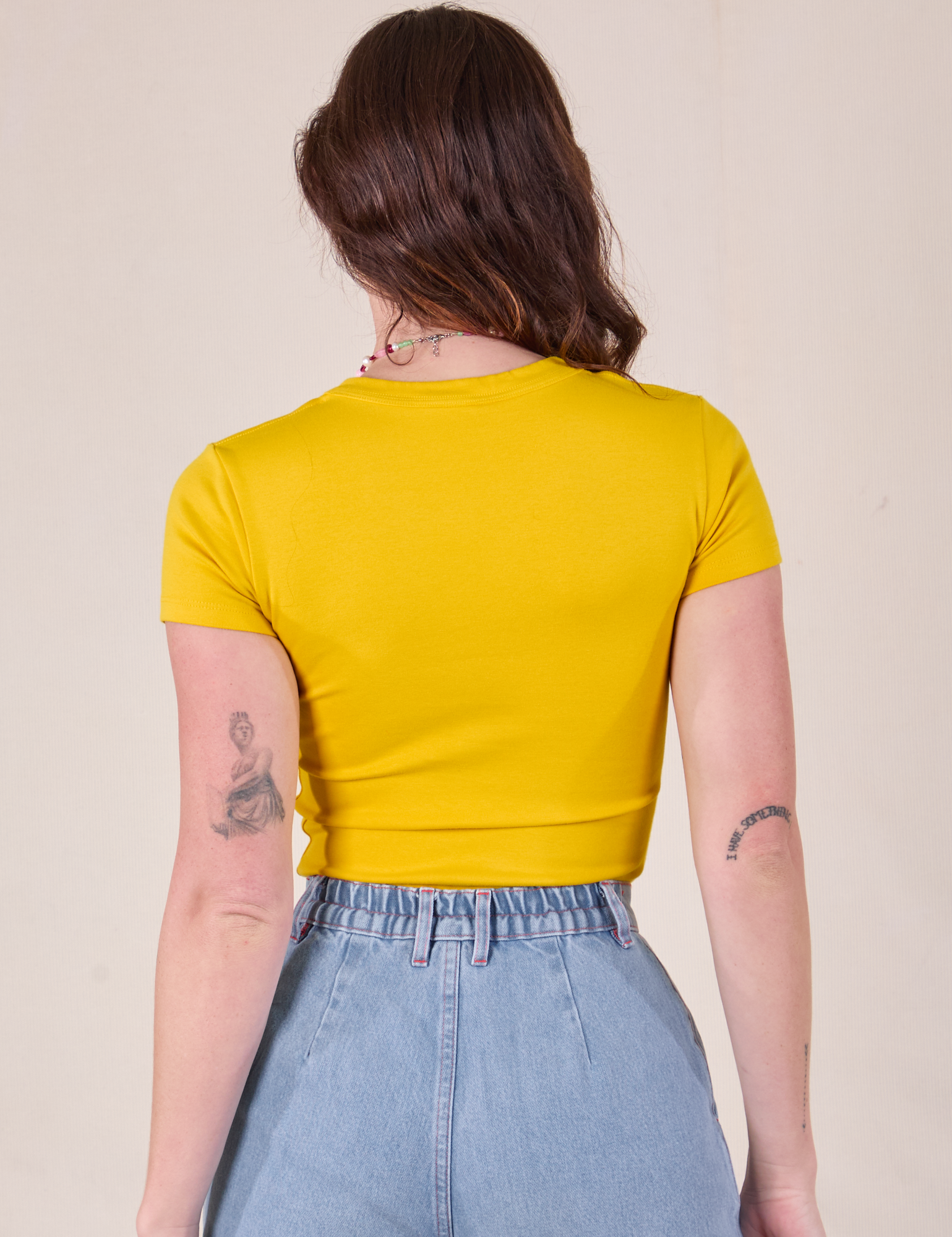 Baby Tee in Golden Yellow back view on Alex