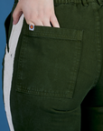 Close up of Sydney's hand in the back pocket of Painted Work Pants in Evergreen