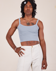 Jerrod is 6'3" and wearing S Cropped Cami in Periwinkle paired with vintage tee off-white Western pants