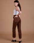 Carpenter Jeans in Fudgesicle Brown angled back view on Alex
