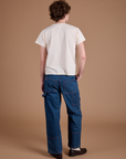 Back view of Carpenter Jeans in Dark Wash and Organic Vintage Tee in Vintage Tee Off-White on Quinn