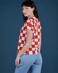 Angled back view of Checker Organic Tee in Red on Alex