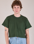 Quinn is 6'3" and wearing M Cropped Burly Tee in Swamp Green