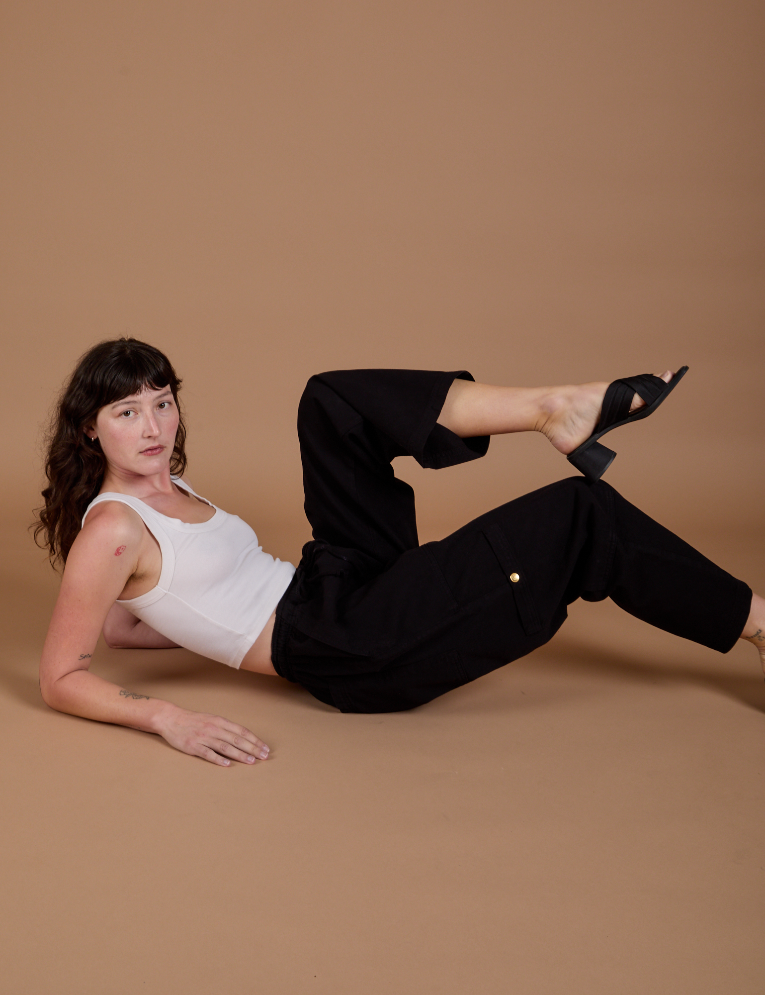 Alex is wearing Drop Pocket Cargo Pants in Basic Black and Cropped Tank in vintage tee white