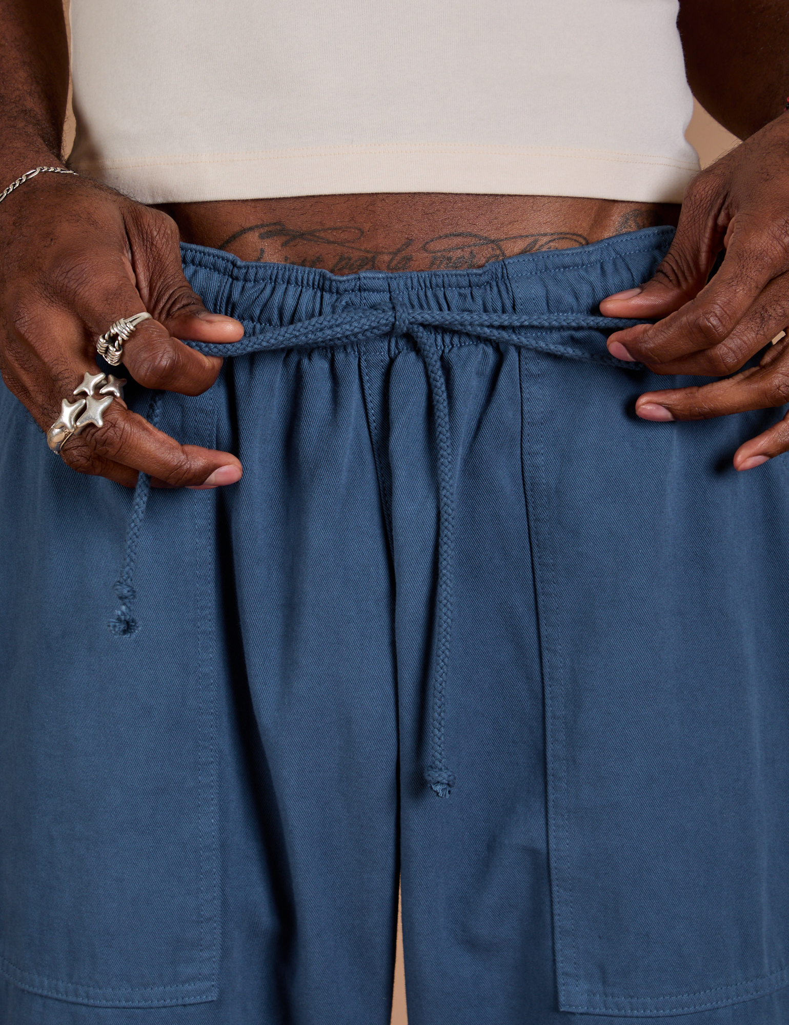 Close up of Jerrod holding the cotton drawstring