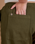 Close up of Juliet's hand in the back pocket of Drop Pocket Cargo Pants in Surplus Green