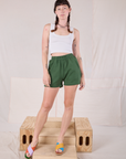 Alex is 5’8” and wearing P Easy Shorts in Dark Emerald Green paired with a Cropped Tank in vintage tee off-white