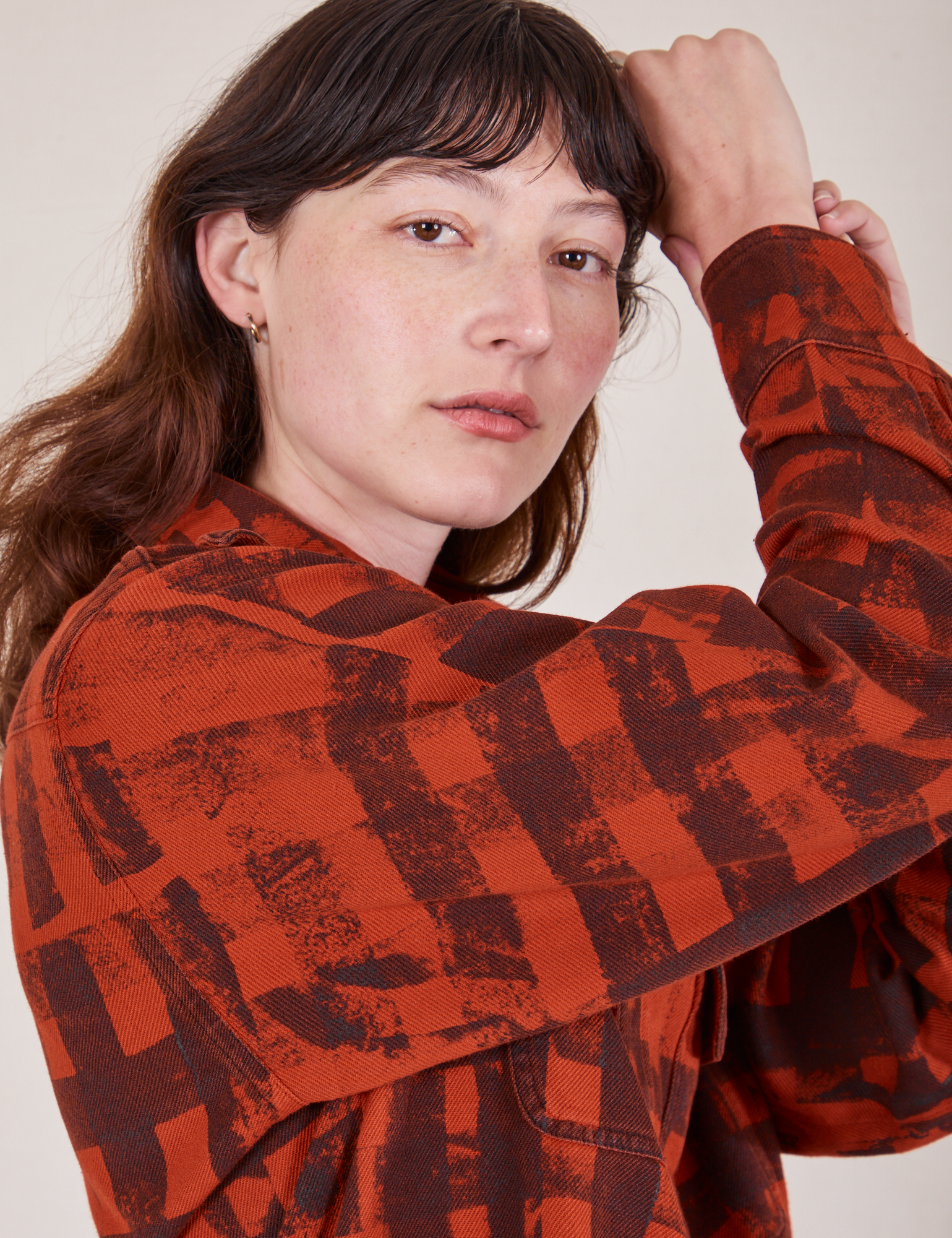 Close up of sleeve side of Plaid Flannel Overshirt in Paprika on Alex