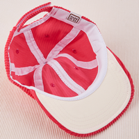Dugout Corduroy Hat in Hot Pink flipped over. White satin under-bill.