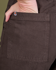 Close up of Alex's hand in the back pocket of Guy Colwell Work Pants in Woman & Man