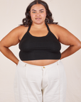 Alicia is 5'9" and wearing XL Halter Top in Basic Black paired with vintage off-white Western Pants