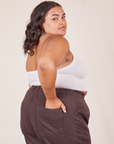 Angled back view of Halter Top in Vintage Tee Off-White and espresso brown Western Pants worn by Alicia. She has her left hand in the back pant pocket.
