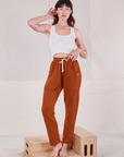 Alex is 5'8" and wearing P Rolled Cuff Sweat Pants in Burnt Terracotta paired with Cropped Tank in vintage tee off-white 