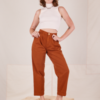 Alex is wearing Heavyweight Trousers in Burnt Terracotta and vintage off-white Sleeveless Turtleneck